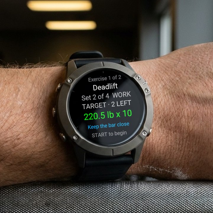 A lifter's wrist on a barbell in a gym. The watch shows BulkForged's next set: Deadlift, set 2 of 4, 220.5 lb for 10 reps.